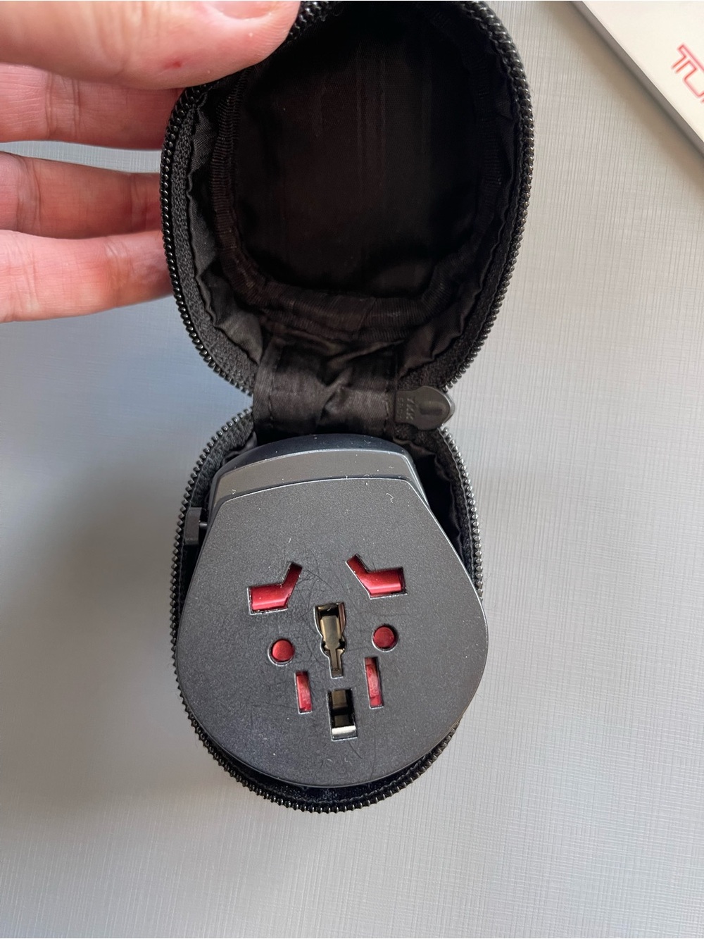 Tumi Black Travel Universal Adapter with Red Accents